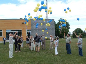 Blue and gold balloons, Brownsville school's colours, are released at the annual reunion last Wednesday afternoon.