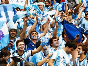 Argentina fans celebrate the team's victory over Nigeria during their World Cup Group F match at Beira Rio Stadium in Porto Alegre. Brazil, June 25, 2014. (STEFANO RELLANDINI/Reuters)