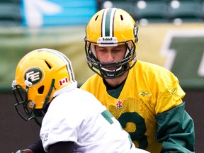 Mike Reilly and Hugh Charles, shown at practice last fall, have seen their connections with the team head in opposite directions in the past week. (Codei McLachlan, Edmonton Sun)
