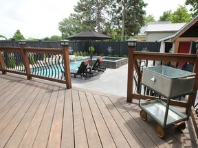 A view from the deck of Jacquie and Todd Gregg?s backyard, where there is a pool with water features, hot tub, deck and pool house. (CRAIG GLOVER, The London Free Press)