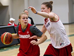 Jamie Weisner, left, and Michelle Plouffe take part in a basketball practice at the Saville Centre. (Codie McLachlan, Edmonton Sun)