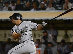 Chicago White Sox designated hitter Jose Abreu  hits a solo home run against the Oakland Athletics on May 12, 2014 at O.co Coliseum. (KYLE TERADA/USA TODAY Sports)