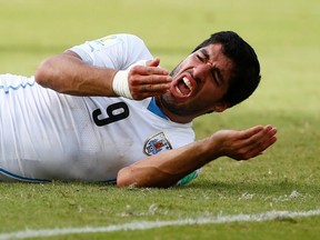 Uruguay's Luis Suarez reacts after clashing with an Italian player during their 2014 World Cup Group D soccer match at the Dunas arena in Natal in this June 24, 2014 file photograph. (REUTERS/Tony Gentile/Files)