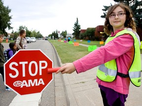 FILE: Ormsby Elementary Grade 6 student Bailey Tanner, 10, works as a  crossing guard outside the school, 6323 - 184 Street, Tuesday Sept. 4, 2012. Tuesday marked the first day back to school following summer vacation, for many Edmonton students. DAVID BLOOM EDMONTON SUN