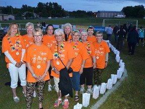 The Pincher Creek Relay for Life organizing committee stands along the luminary-lined track at the Agricultural Society soccer field on Saturday, June 21. The town's first-ever Relay raised over $39,000 in the fight against cancer. John Stoesser photo/QMI Agency.