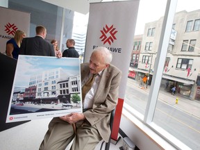 Fred Kingsmill holds an artist rendering that shows Fanshawe College's plan for the Kingsmill's building. (Free Press file photo)