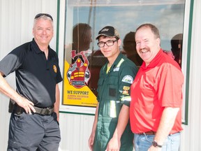Whitecourt fire chief Brian Wynn (left) delivered a volunteer firefighter supporter decal to HSE Integrated in Whitecourt on Friday, June 20, assisted by HSE employee and volunteer firefighter Nolan Brown (centre) and HSE station manager Tom Pickard (right.) The decal is part of a province-wide initiative to recognize employers who hire and support volunteer firefighters. Bryan Passifiume photo | Whitecourt Star