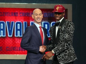 Andrew Wiggins shakes hands with NBA commissioner Adam Silver after being selected first overall by Cleveland Cavaliers in the NBA Draft at the Barclays Center in New York, June 26, 2014. (BRAD PENNER/USA Today)
