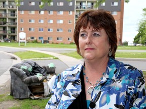 Mary Lynn Cousins Brame, the chief executive officer of the Kingston & Frontenac Housing Corporation, with garbage on Compton Street in Kingston on Thursday.  (Ian MacAlpine/The Whig-Standard)