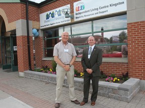 Home Base Housing executive director Tom Greening, left,  and president Bill Dobson stand outside the Home Base Housing and Independent Living Centre Kingston's new location at 540 Montreal St. Julia McKay/The Whig-Standard