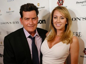 Actor Charlie Sheen and his fiancee Scottine grace the red carpet at the Joe Carter Classic after-party in support of children's charities on June 26, 2014. (Stan Behal/Toronto Sun)