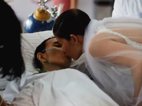 Rowden Go kisses his bride Leizel during their nuptials at his hospital bedside. (YouTube screengrab)