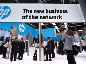 A visitor takes a photo with a tablet in front of a Hewlett-Packard (HP) stand at the Mobile World Congress in Barcelona in this file photo from Feb. 27, 2014.   REUTERS/Albert Gea/Files