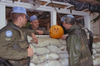 A touch of home on Hallowe'en in Croatia: Private Jason Andrews carves while Sergeant Steve Little and Corporal Fritz supervise, 1993. (SUPPLIED)