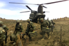 Heavily weighted with ammunition, rations, water and personal gear, soldiers of 3 PPCLI dismount from a US CH-47D Chinook helicopter, during Operation TOR II, Tora Bora region, Afghanistan, 7 May 2002. (SUPPLIED)