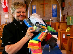 Canon Suzanne Craven, of  the Church of the Epiphany in Oakville, holds the socks donated for the homeless on June 27, 2014. (Dave Abel/Toronto Sun)