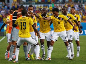 Colombia's team celebrates Juan Cuadrado's goal against Japan during their 2014 World Cup Group C soccer match at the Pantanal arena in Cuiaba June 24, 2014. (REUTERS/Jorge Silva)