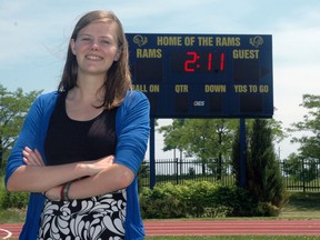 Jenna Mitchell stands in front of the football scoreboard at St. Joseph's Catholic High School in St. Thomas. Mitchell graduated from St. Joe's this week with many awards, including The Elisabeth Charlene Steel Reurink Children of the Light Memorial Award Scholarship. Ben Forrest/Times-Journal