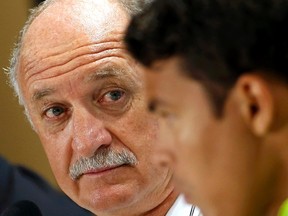 Brazil's national soccer head coach Luiz Felipe Scolari (L) attends a news conference with player Thiago Silva a day before their World Cup soccer match against Chile at the Mineirao stadium in Belo Horizonte June 27, 2014. (REUTERS/Eric Gaillard)