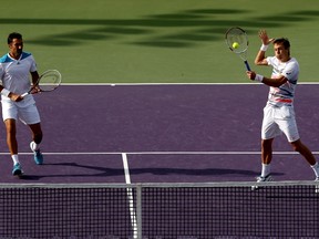 Nenad Zimonjic of Serbia and Daniel Nestor of Canada play Ryan Harrison and Jack Sock during the Sony Open at the Crandon Park Tennis Center on March 26, 2014 in Key Biscayne, Florida. (Matthew Stockman/Getty Images/AFP)