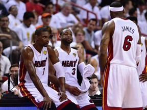Miami Heat forward LeBron James (6) talks with center Chris Bosh (1), guard Dwyane Wade (3) during the second quarter of game four of the 2014 NBA Finals against the San Antonio Spurs at American Airlines Arena on Jun 12, 2014 in Miami, FL, USA. (Bob Donnan-USA TODAY Sports)