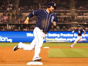 San Diego Padres third baseman Chase Headley (7) heads home to score the winning run in the 11th inning against the Washington Nationals at Petco Park on June 7, 2014. (STAN LIU/USA TODAY Sports)