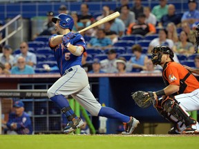 New York Mets third baseman David Wright (5) hits a sacrifice fly during the third inning against the Miami Marlins at Marlins Ballpark on Jun 22, 2014 in Miami, FL, USA. (Steve Mitchell/USA TODAY Sports)