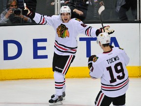 Chicago Blackhawks right wing Patrick Kane (88) celebrates his goal scored against the Los Angeles Kings with center Jonathan Toews (19) during the third period at Staples Center on Feb 3, 2014 in Los Angeles, CA, USA. (Gary A. Vasquez-USA TODAY Sports)