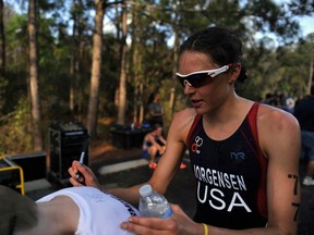U.S. Olympic triathlete Gwen Jorgensen autographs a young fan's shirt in Clermont, Florida March 3, 2012. Jorgensen, who completed her first competitive triathlon in Clermont just two years before REUTERS/Octavian Cantilli