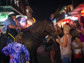 A mounted policeman reacts as revelers surround his horse on Bourbon Street, located in the French Quarter of New Orleans, Louisiana on June 7, 2014.  REUTERS/Adrees Latif