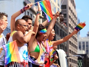 Pride parade participants wave to spectators along Yonge St. (ERNEST DOROSZUK, Toronto Sun)