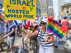 Toronto Sun columnist Sue-Ann Levy (right) and her wife, Denise Alexander, are pictured in Sunday's WorldPride parade. (ERNEST DOROSZUK, Toronto Sun)
