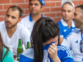 Despondent soccer fans are pictured on Danforth Ave. on Sunday. (ERNEST DOROSZUK, Toronto Sun)