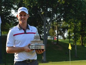 Justin Rose holds the Quicken Loans National trophy up after defeating Shawn Stephani in a one-hole playoff on the 18th green in Bethesda, Md., on Sunday, June 29, 2014. (Tommy Gilligan/USA TODAY Sports)