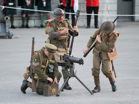 Members with 46th Productions demonstrate how to carry and load a Vickers Medium Machine Gun during a special event at Fort Henry on Saturday. The Tribute to the Great War commemorated Canada's participation in the First World War through music, period uniforms, equipment and more. Julia McKay/The Whig-Standard