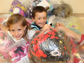 Ryan Byrne/For The Sudbury Star   
Isabelle Perry, left, and Keir Gauld show off a batch of tie-blankets for the Family and Child Program at Health Sciences North.