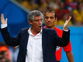 Greece's coach Fernando Santos gestures in front of fourth official Nawaf Shukralla during their World Cup game against Costa Rica at the Pernambuco arena in Recife, Brazil on Sunday, June 29, 2014. (Tony Gentile/Reuters)