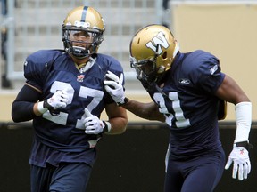 Winnipeg Blue Bombers linebacker Teague Sherman (left) runs a drill with defensive back Maurice Leggett during CFL football practice in Winnipeg, Man. Sunday June 29, 2014.
Brian Donogh/Winnipeg Sun/QMI Agency