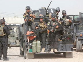 Members of the Iraqi Special Operations Forces (ISOF) prepare before going out on a patrol in the town of Jurf al-Sakhar, south of Baghdad, June 30, 2014. REUTERS/Alaa Al-Marjani