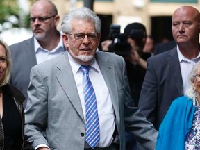Entertainer Rolf Harris arrives with his daughter Bindi (L) and wife Alwen (R) at Southwark Crown Court in London June 23, 2014.  REUTERS/Luke MacGregor