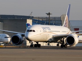 A United Airlines 787 Dreamliner passenger jet taxis past a Japan Airlines 787 at New Tokyo international airport, in this January 17, 2013 file photo. (REUTERS/Toru Hanai/Files)