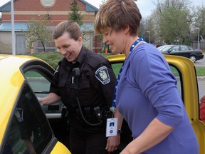 St. Thomas Police Const. Tanya Calvert and VON volunteer Alice Baughman load hot meals from the St. Thomas Seniors Centre for delivery to Meals on Wheels clients. In total 37 meals were delivered with the assistance of constables Calvert, Jeff De Leeuw and Brian Kempster as part of Police Week activities.