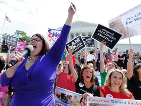 Kristan Hawkins of Students for Life leads anti-abortion demonstrators as they cheer after the ruling for Hobby Lobby was announced outside the U.S. Supreme Court in Washington June 30, 2014.  REUTERS/Jonathan Ernst