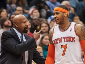New York Knicks head coach Mike Woodson talks to forward Carmelo Anthony in the fourth quarter against the Minnesota Timberwolves at Target Center on March 5, 2014. (Brad Rempel/USA TODAY Sports)