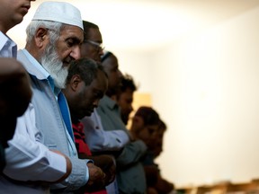 A man pauses in prayer following the meal at the Lloydminster Islamic Centre. (Files)