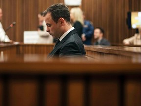 South African Olympic and Paralympic athlete Oscar Pistorius sits in the dock during his murder trial in the North Gauteng High Court in Pretoria June 30, 2014. (REUTERS/Ihsaan Haffejee/Pool)
