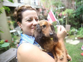 Denise Alexander — wife of Toronto Sun columnist Sue-Ann Levy  — cuddles with Fritz. (JACK BOLAND, Toronto Sun)