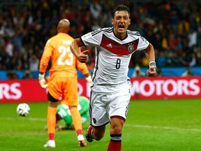 Germany's Mesut Ozil celebrates after scoring his team's second goal against Algeria during extra time in their World Cup game at the Beira Rio stadium in Porto Alegre, Brazil on Monday, June 30, 2014. (Darren Staples/Reuters)