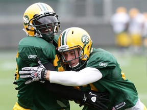 JC Sherritt, shown here at practice with Rennie Curran, has been absent from practice with a lower-body injury. (David Bloom, Edmonton Sun)