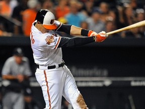 Baltimore Orioles third baseman Manny Machado (13) singles in the seventh inning against the Chicago White Sox at Oriole Park at Camden Yards. Mandatory Credit: Joy R. Absalon-USA TODAY Sports